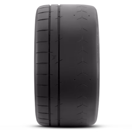 Close-up of a black car tire showing detailed tread grooves along the center and edges.